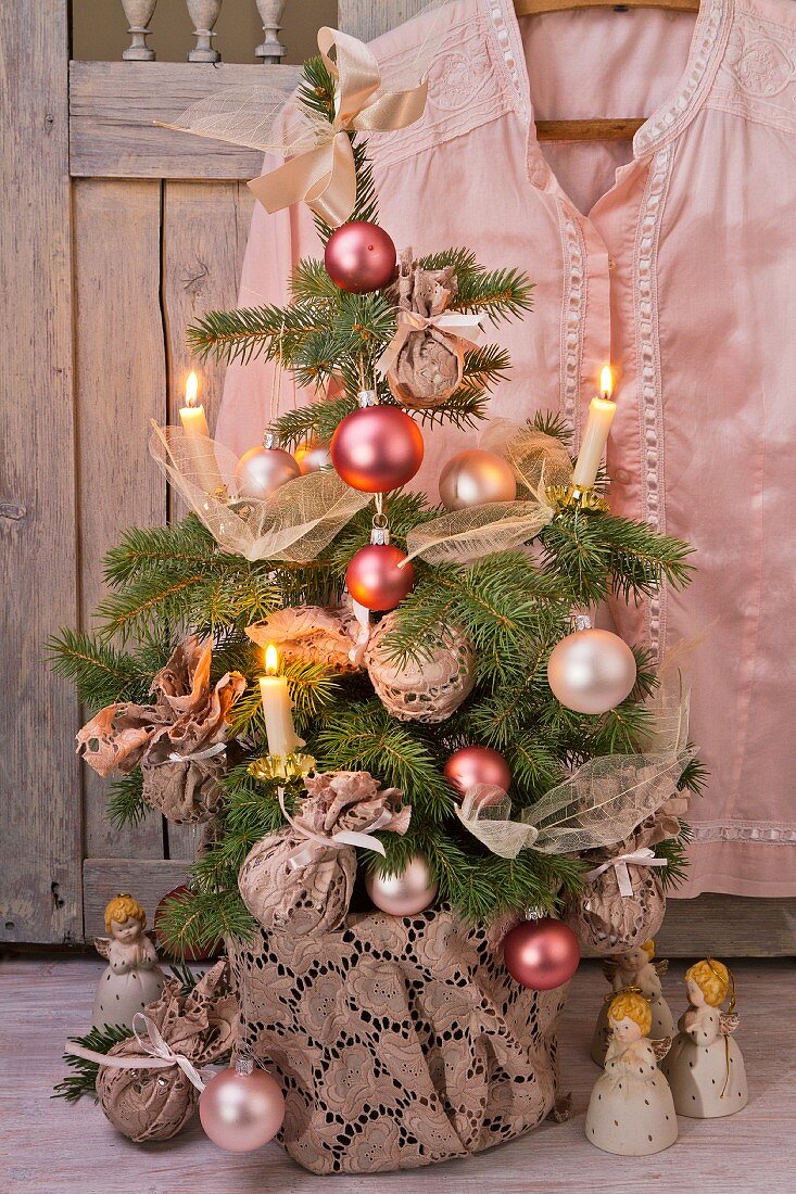 Little Christmas tree with romantic decorations