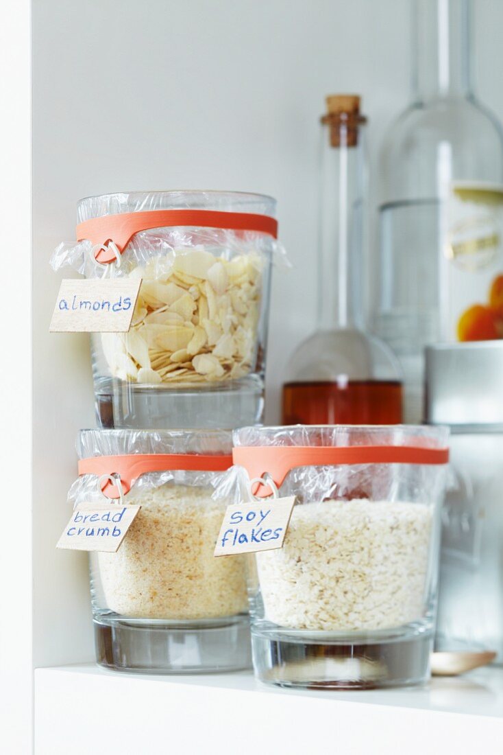 Kitchen supplies in jars sealed with cling film and preserving jar rubber bands