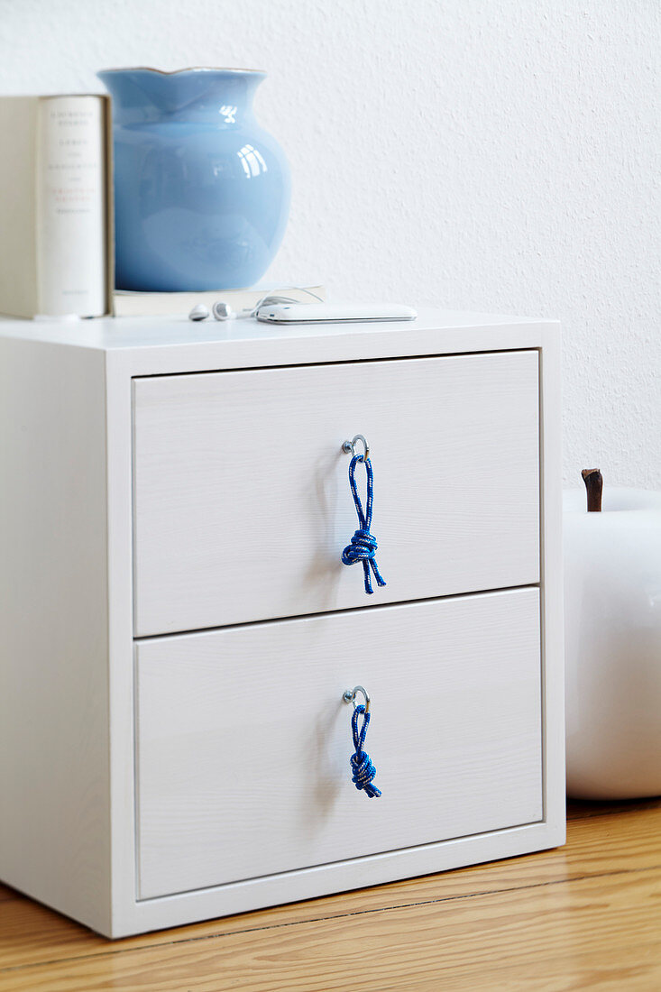 White bedside table with hand-made cord drawer handles