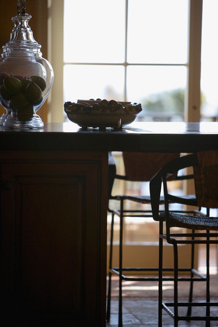 Ausschnitt einer Küchentheke mit Stühlen vor Terrassentür