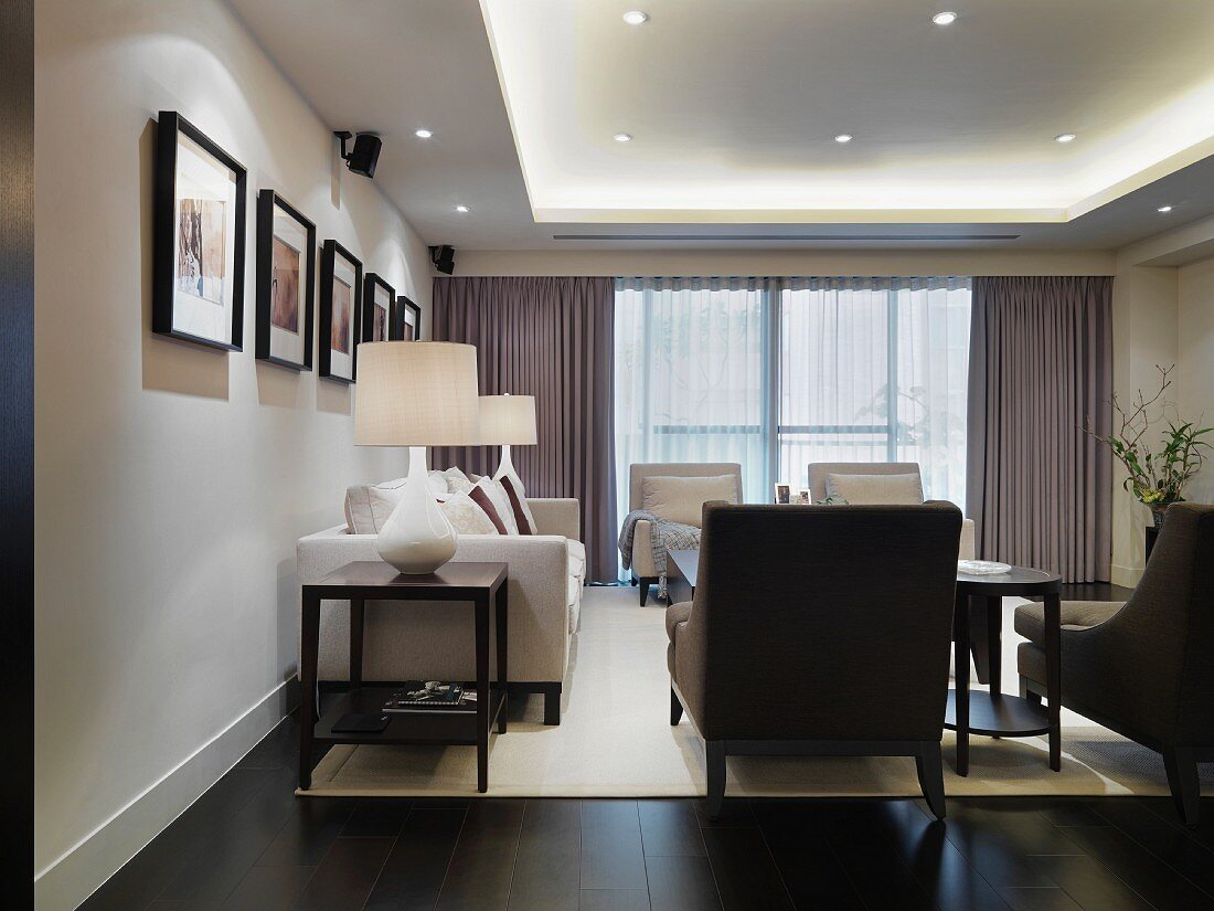 Eleganter Wohnraum mit Polstergarnitur im klassischen Stil und moderner indirekter Beleuchtung