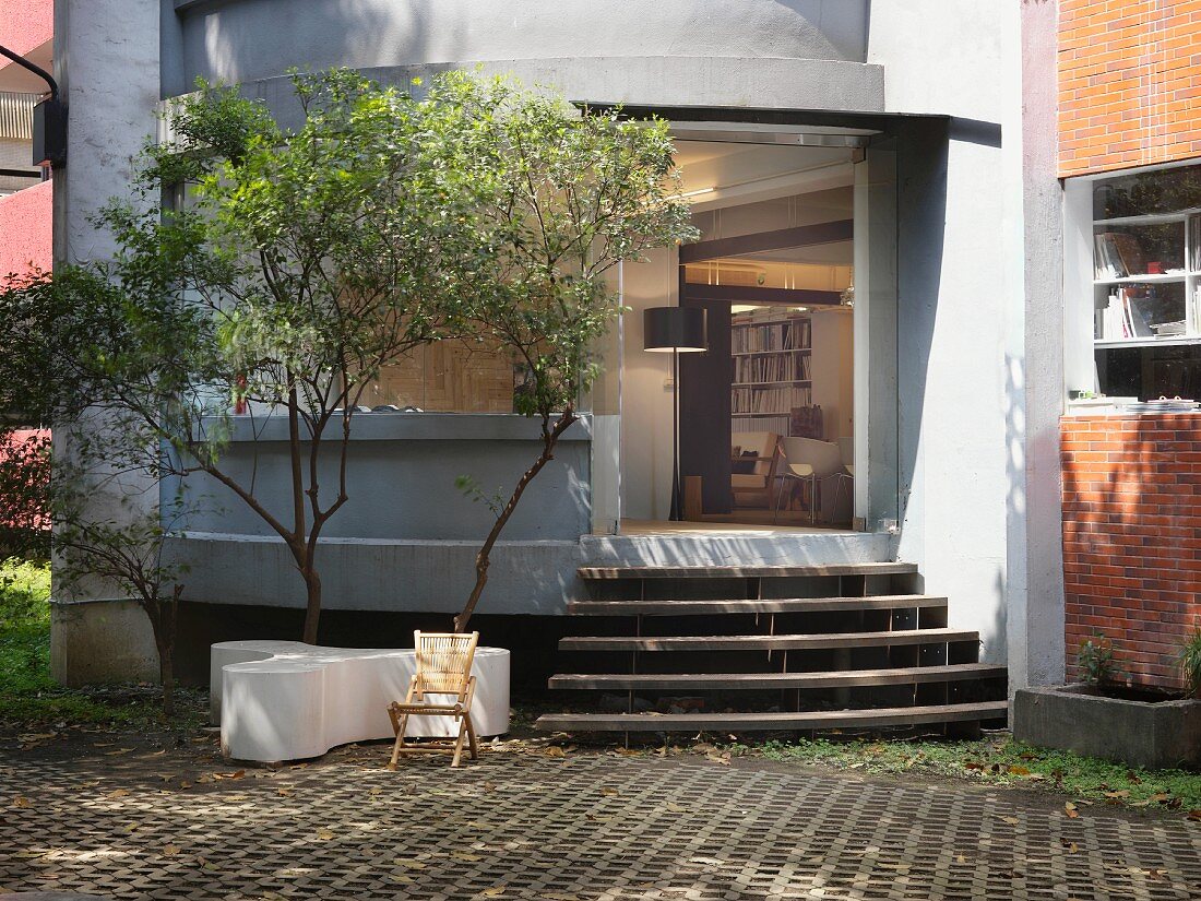 Simple courtyard of apartment building with steps and view of interior