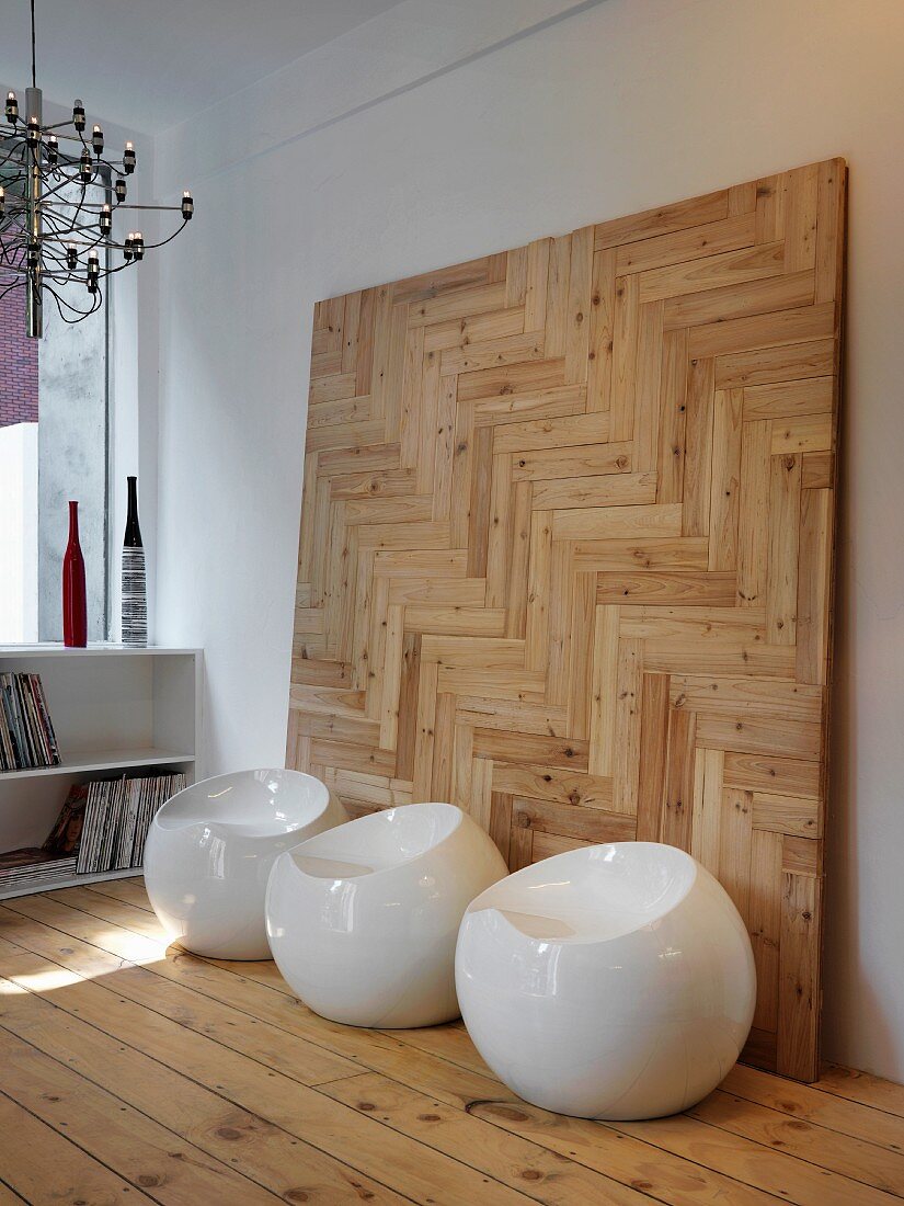 Modern, white plastic stools on simple floor boards