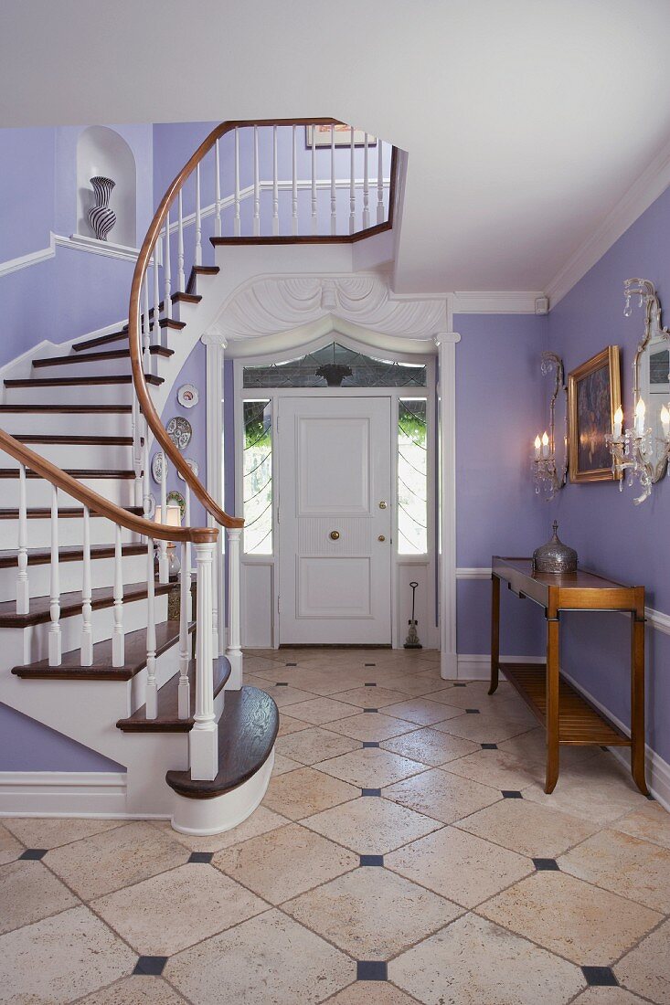 Elegant, pastel foyer with staircase