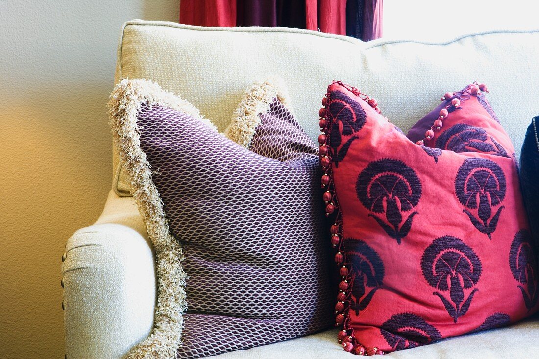 White Sofa with Red Decorative Pillows