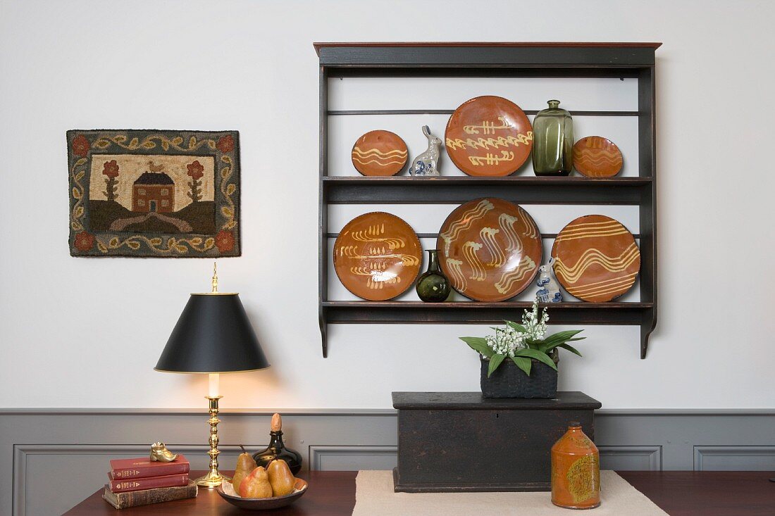 Simple dining room with ethnic painted plates on wall-mounted shelves