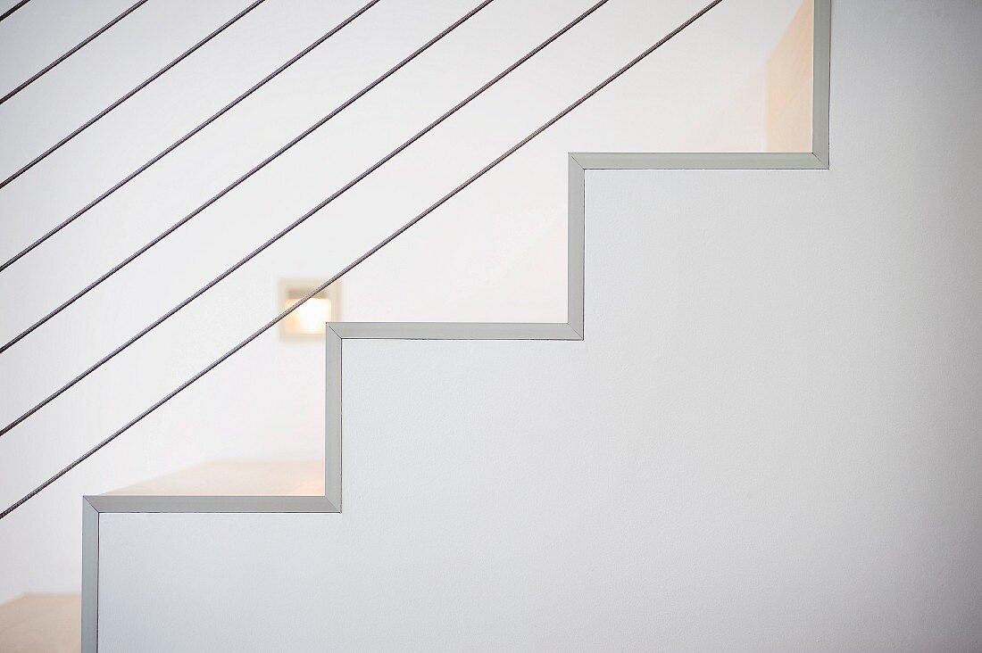 Detail white staircase and wire railing