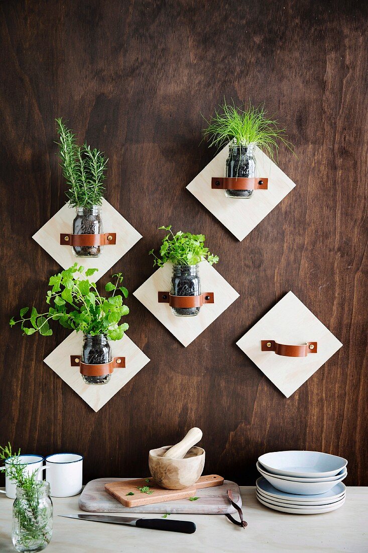 Wall brackets for screw jars with kitchen herbs