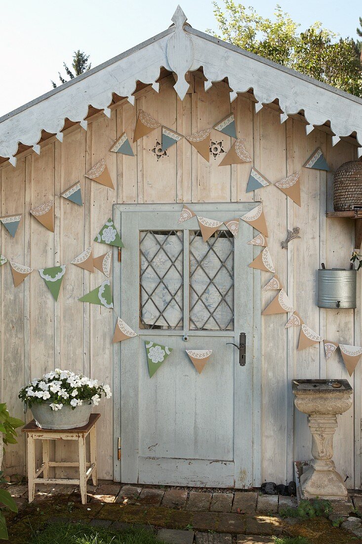 Pretty garden shed decorated with hand-made bunting