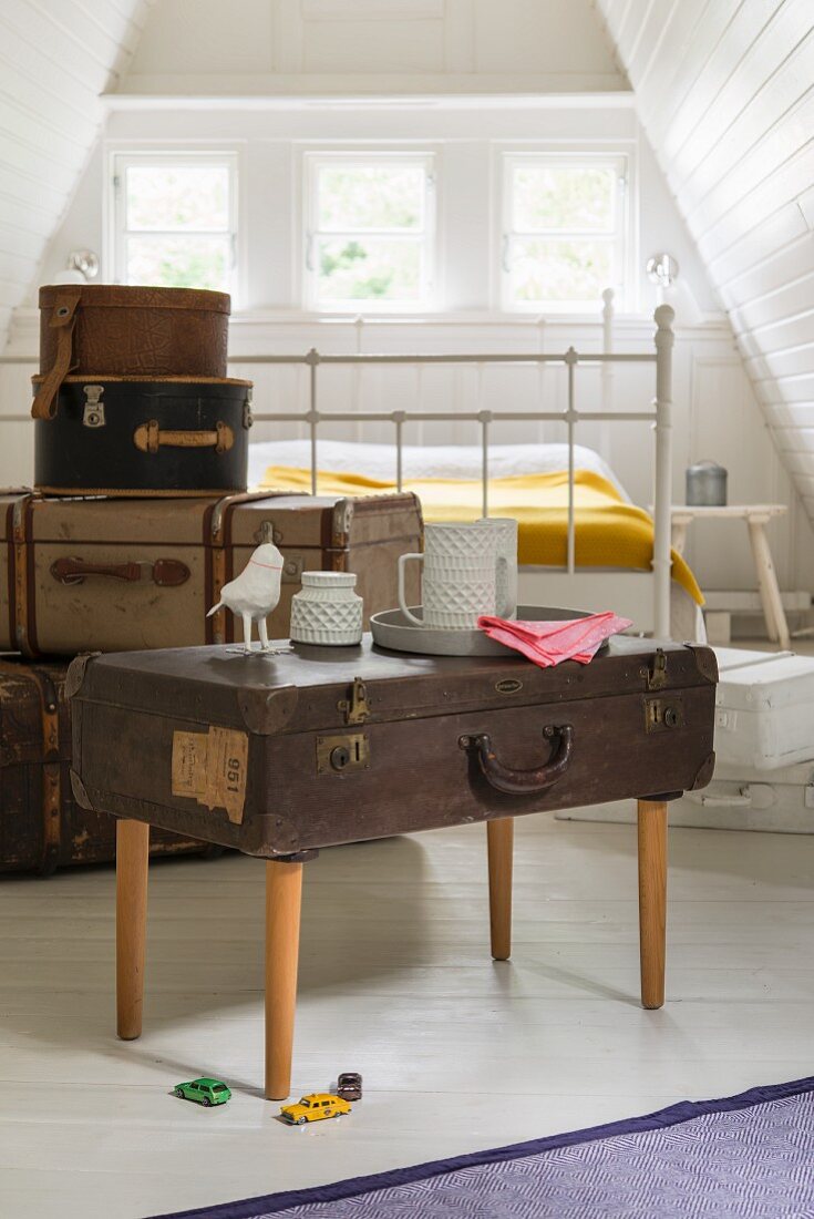 A brown antique suitcase converted into a table
