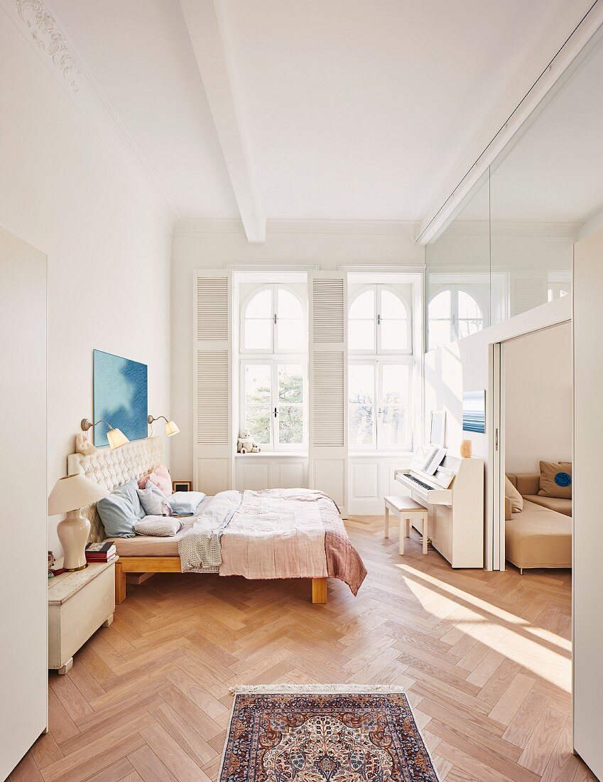Schlafzimmer mit Doppelbett, Klavier & Fischgrätparkett in modernisiertem Gründerzeitbau