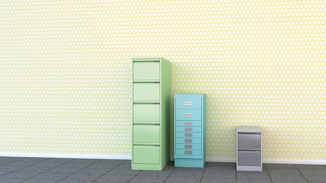 Three different filing cabinets against yellow polka-dot wallpaper