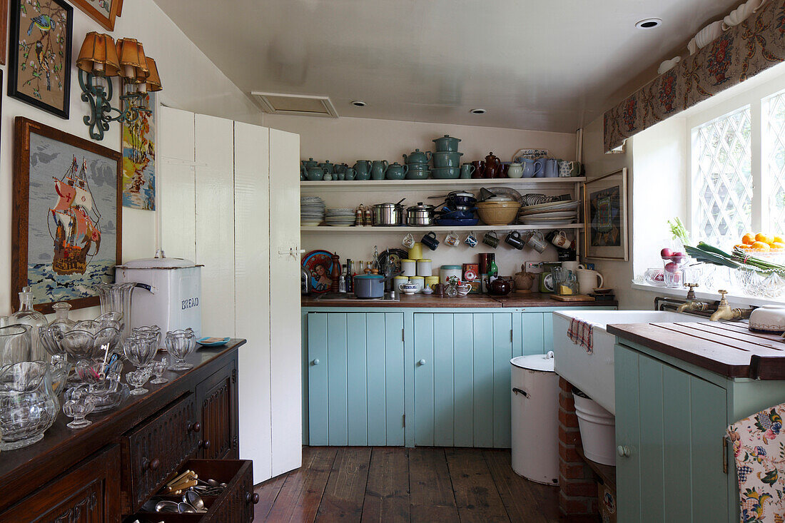 Pale blue wooden cupboards in old-fashioned kitchen