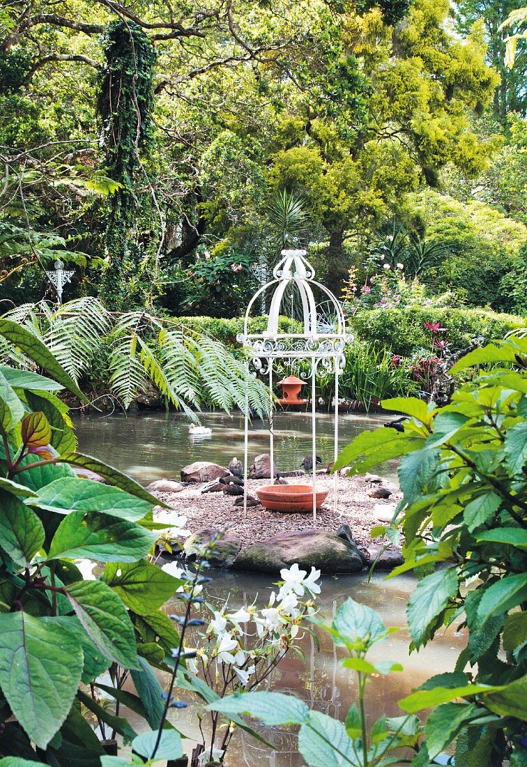 Small wrought iron pavilion in garden pond