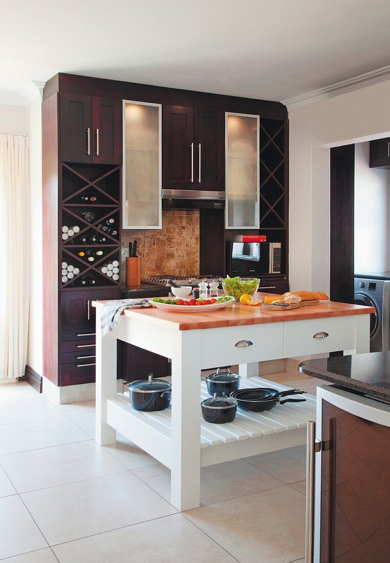White-painted butcher's block in open-plan kitchen with dark fitted cupboards