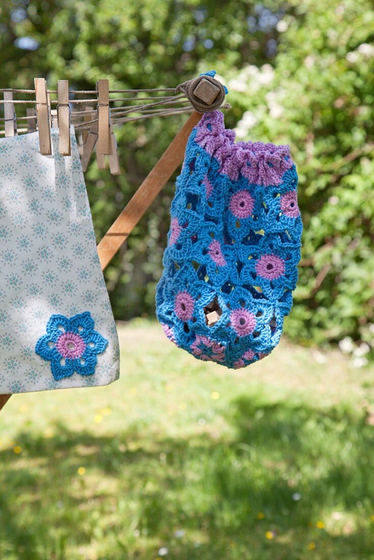 Hand-made, blue and purple peg bag hanging from clotheshorse