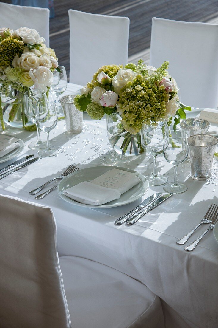 Festlich geschmückter Hochzeitstisch, Blumenstrauss aus weissen Rosen auf weisser, Tischdecke