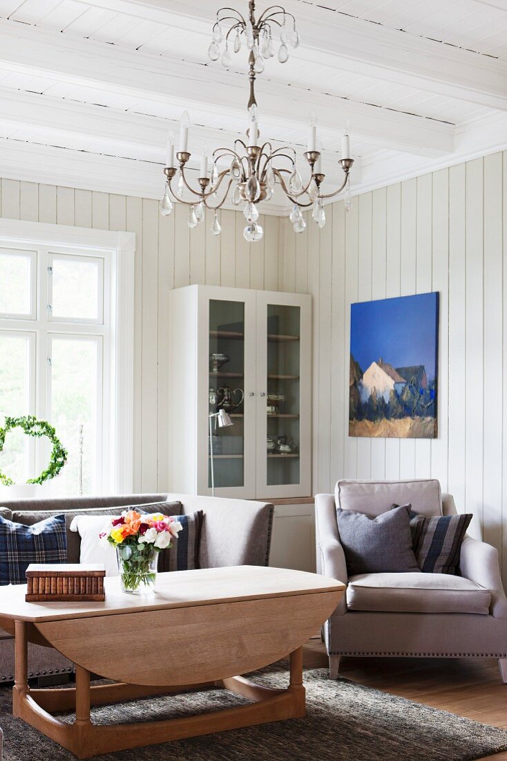 Rustic living room with wood-beamed ceiling and wood-panelled walls
