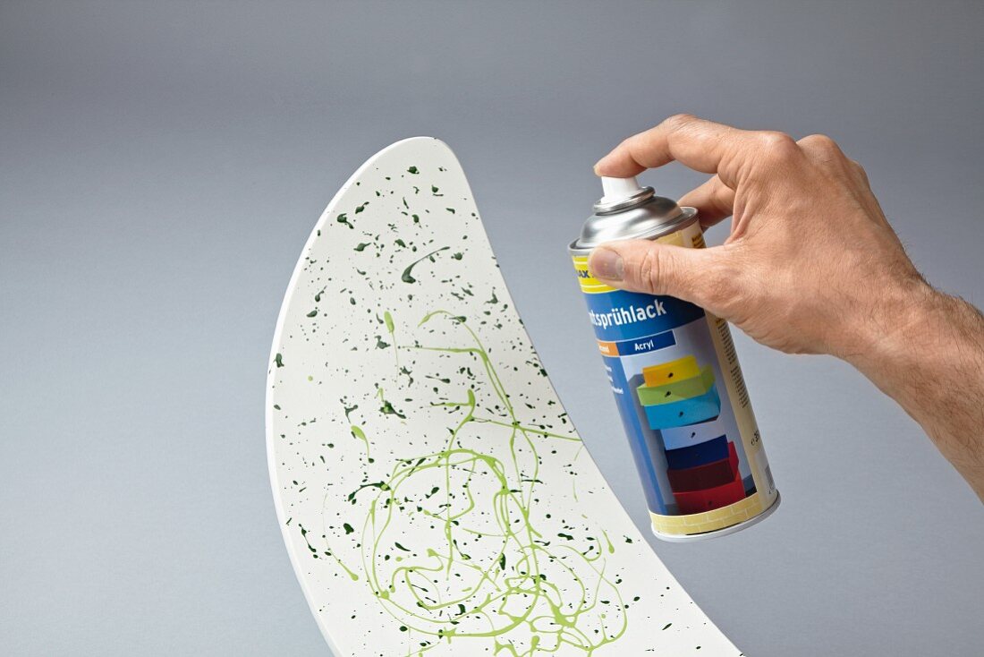 Decorating a chair backrest with splashes of paints and fixing with clear spray lacquer