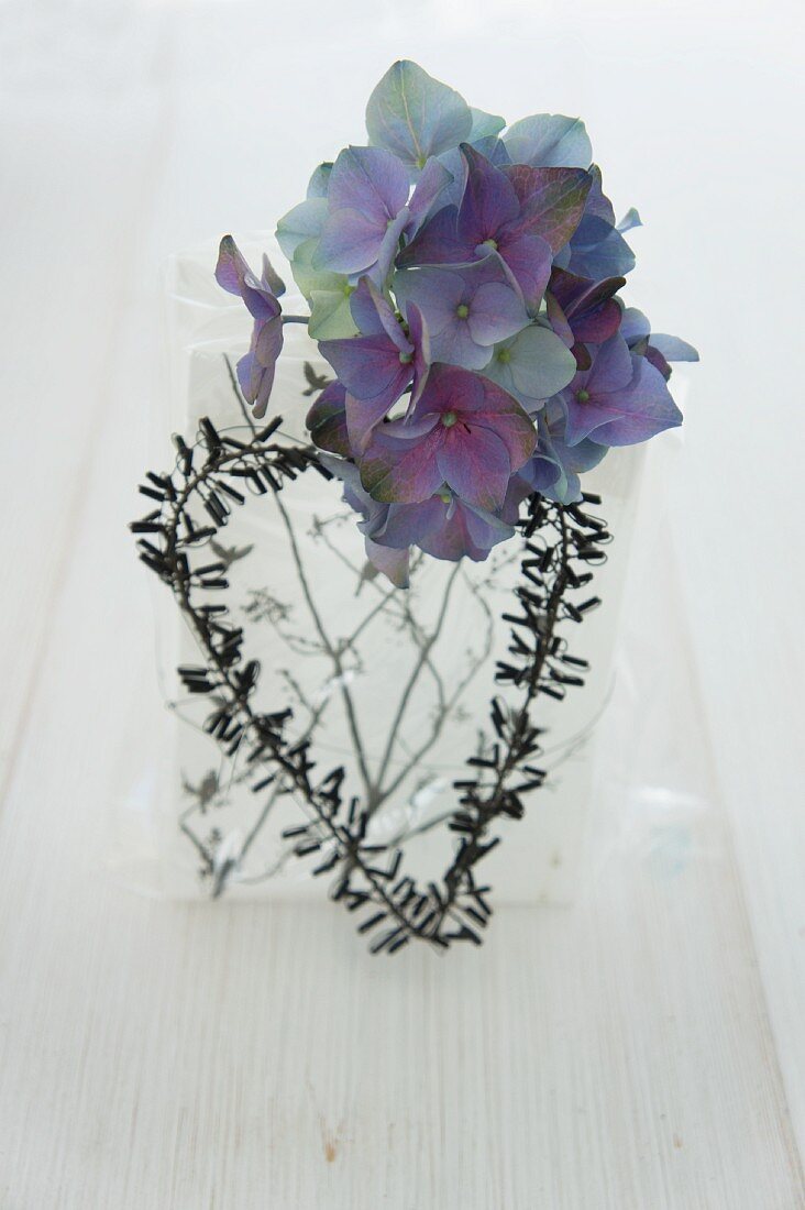 A gift decorated with a hydrangea and a heart