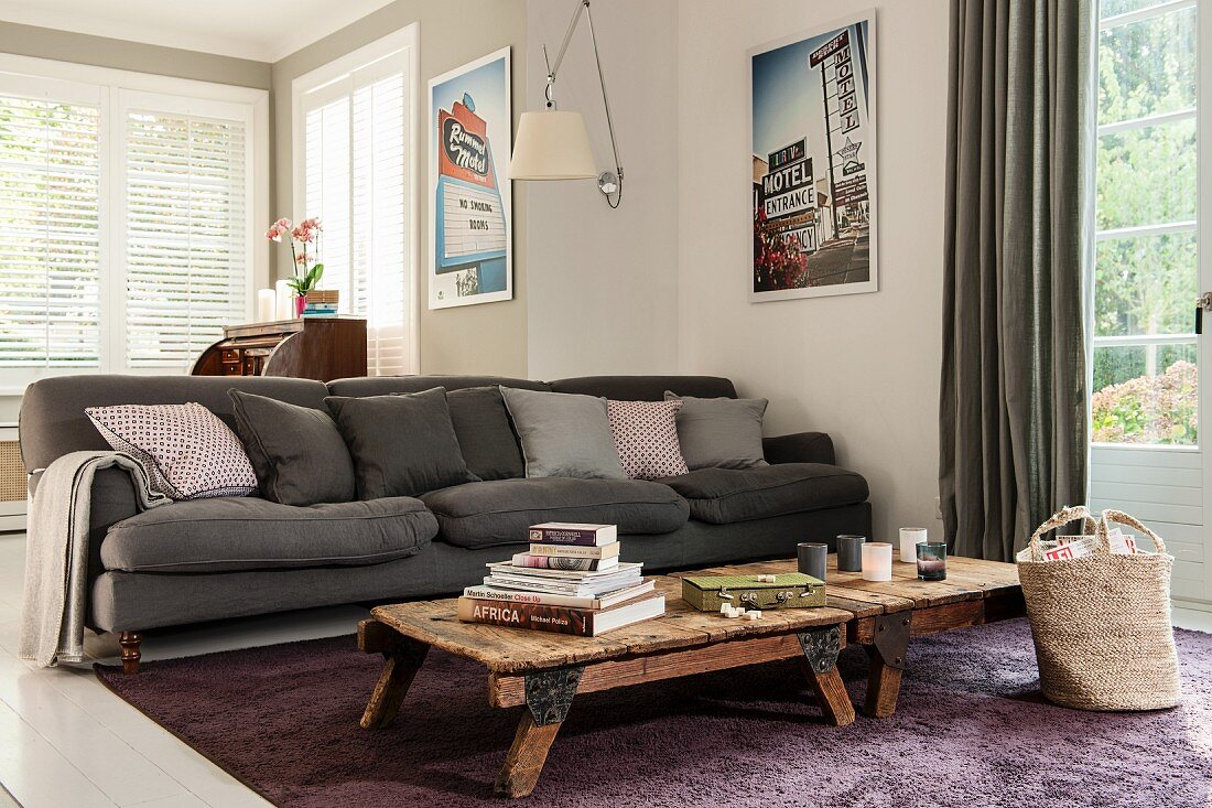 Rustic coffee table in front of dark grey sofa in living room