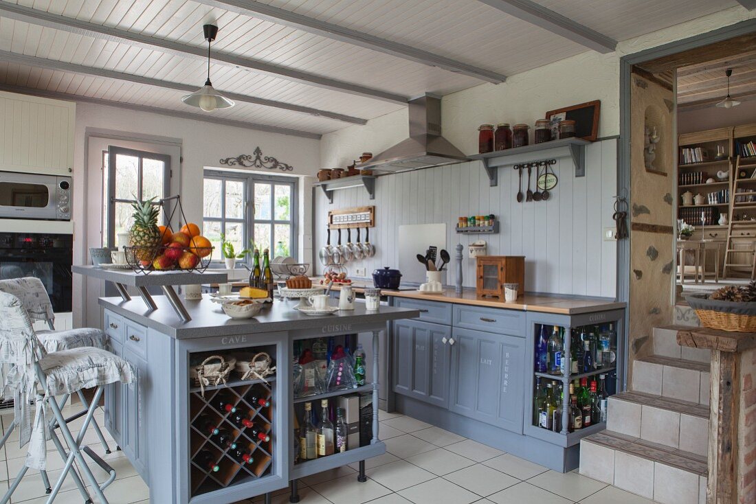 Free-standing, country-house-style island counter painted blue-grey in open-plan kitchen