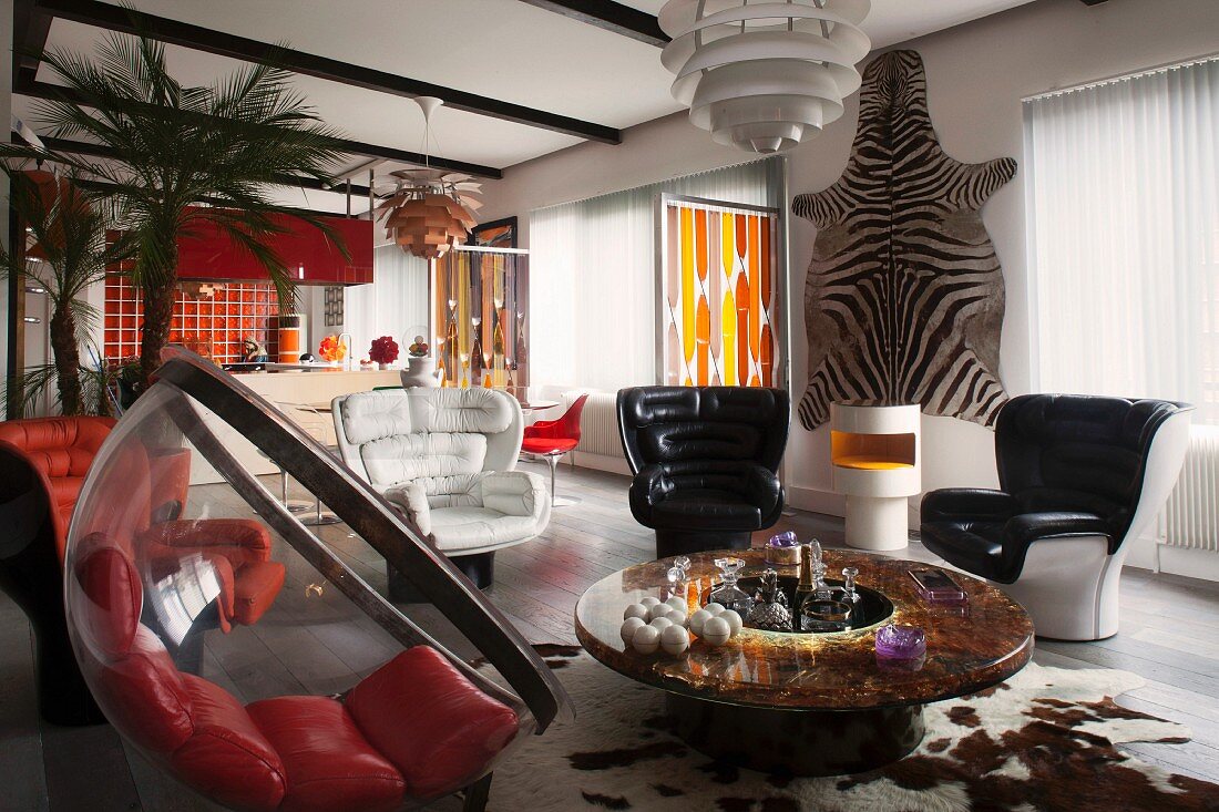 Elegant retro-style lounge area with zebra skin on wall in open-plan interior