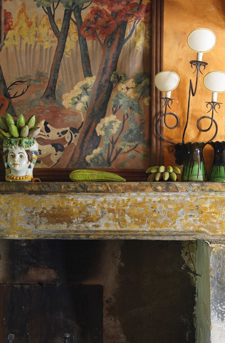 China ornament and vases on mantelpiece with peeling paint