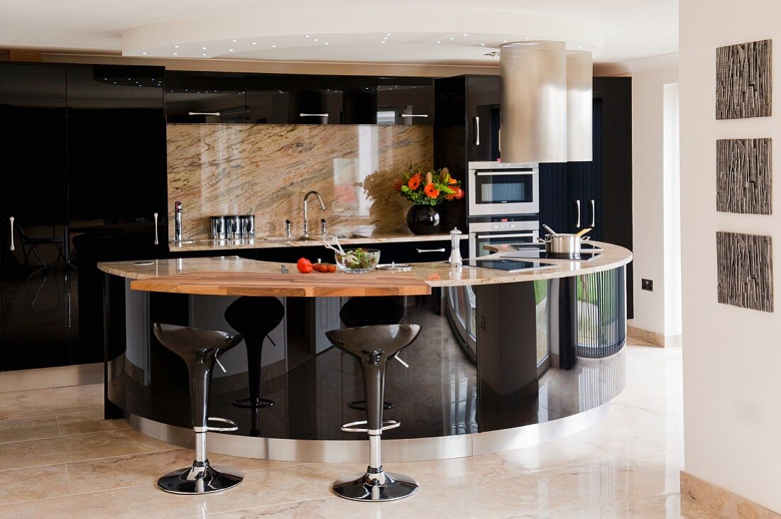 Black glossy kitchen with semicircular designer counter