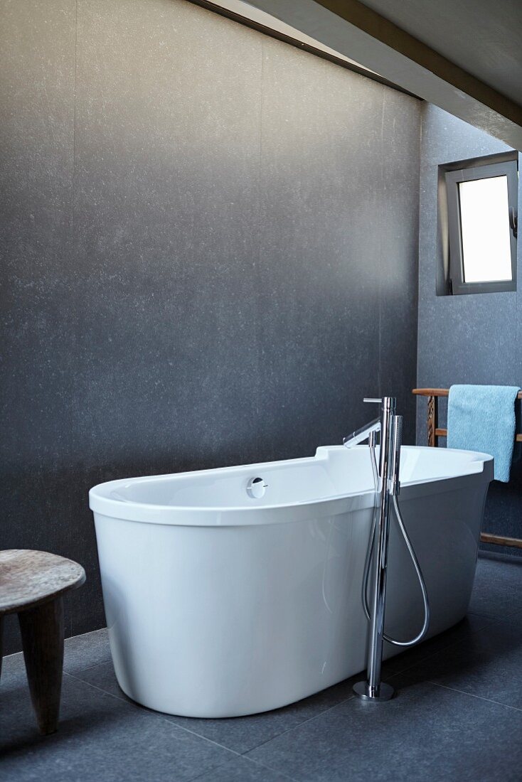 Free-standing bathtub in minimalist bathroom
