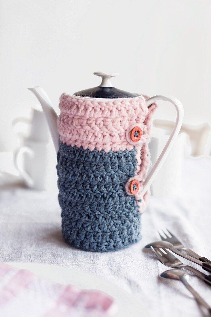 Crocheted cosy in pink and grey-blue on vintage coffee pot