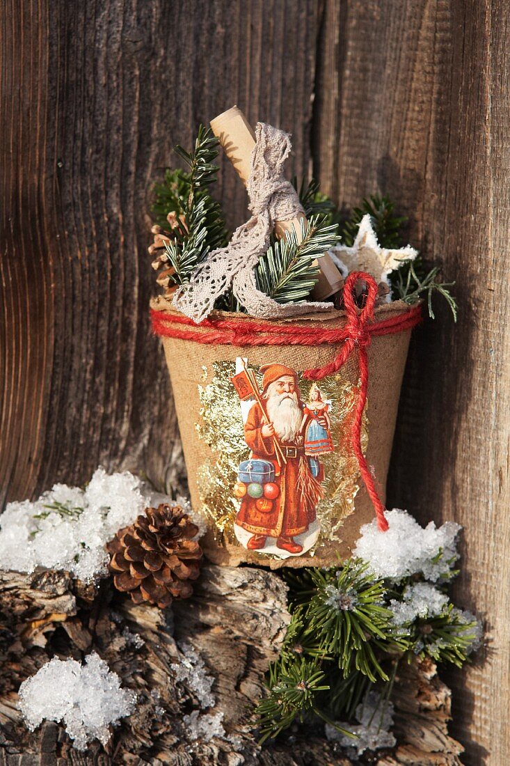Papier mâché plant pot decorated with festive vintage scrapbook pictures