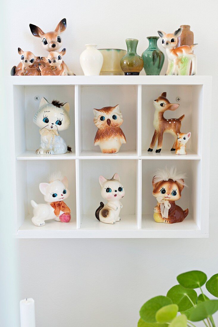 Retro animal figurines in white display case