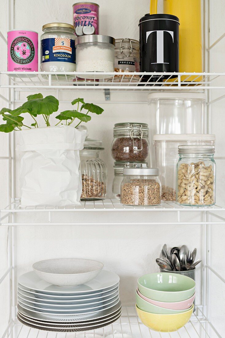 Storage jars and crockery on open kitchen shelves