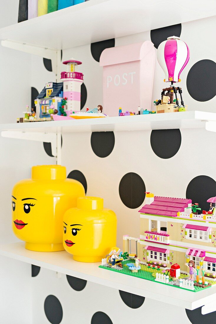 Shelves of toys on polka-dot wall