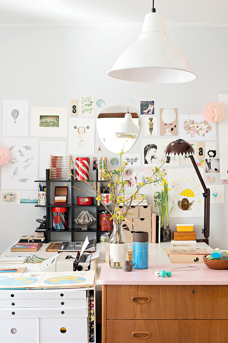 Retro chest of drawers and collage in workspace