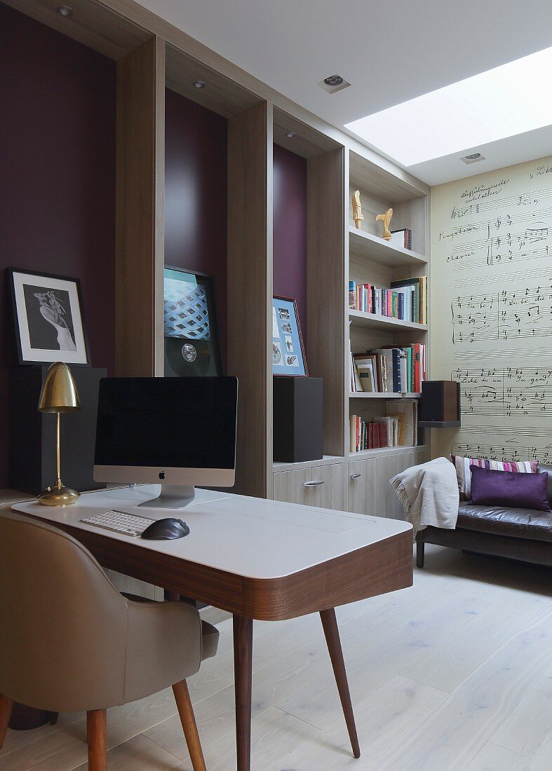 Elegant retro-style desk and chair, custom-made floor-to-ceiling cabinets with integrated bookshelves, framed records and mural of musical notation