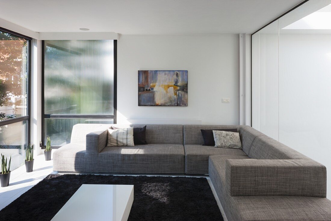 Living room with glass walls in modern building