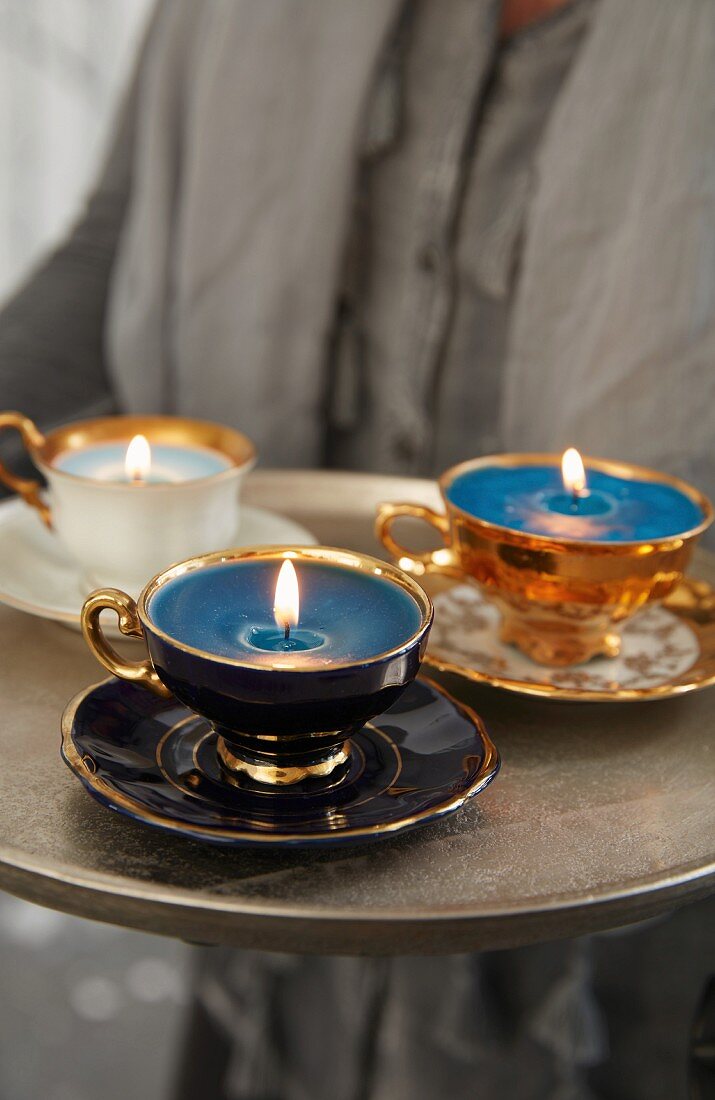 Collective cups filled with wax used as candles on a tray