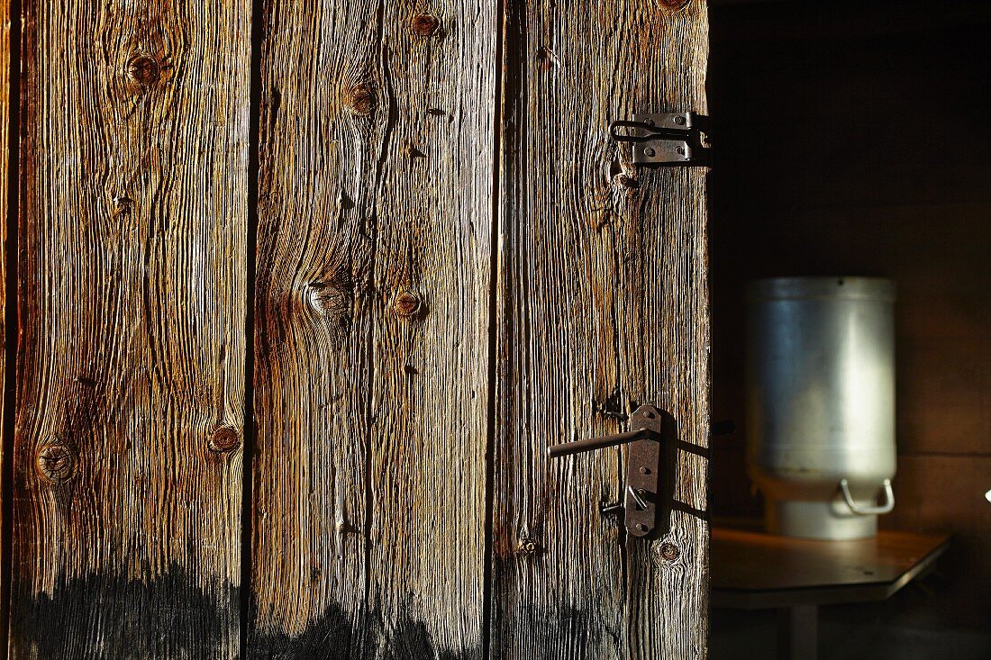 Rustic wooden door and milk churn