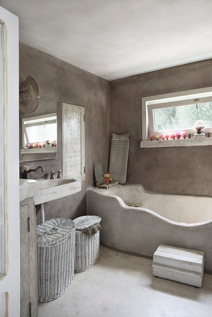 Masonry bathtub in grey limewashed bathroom