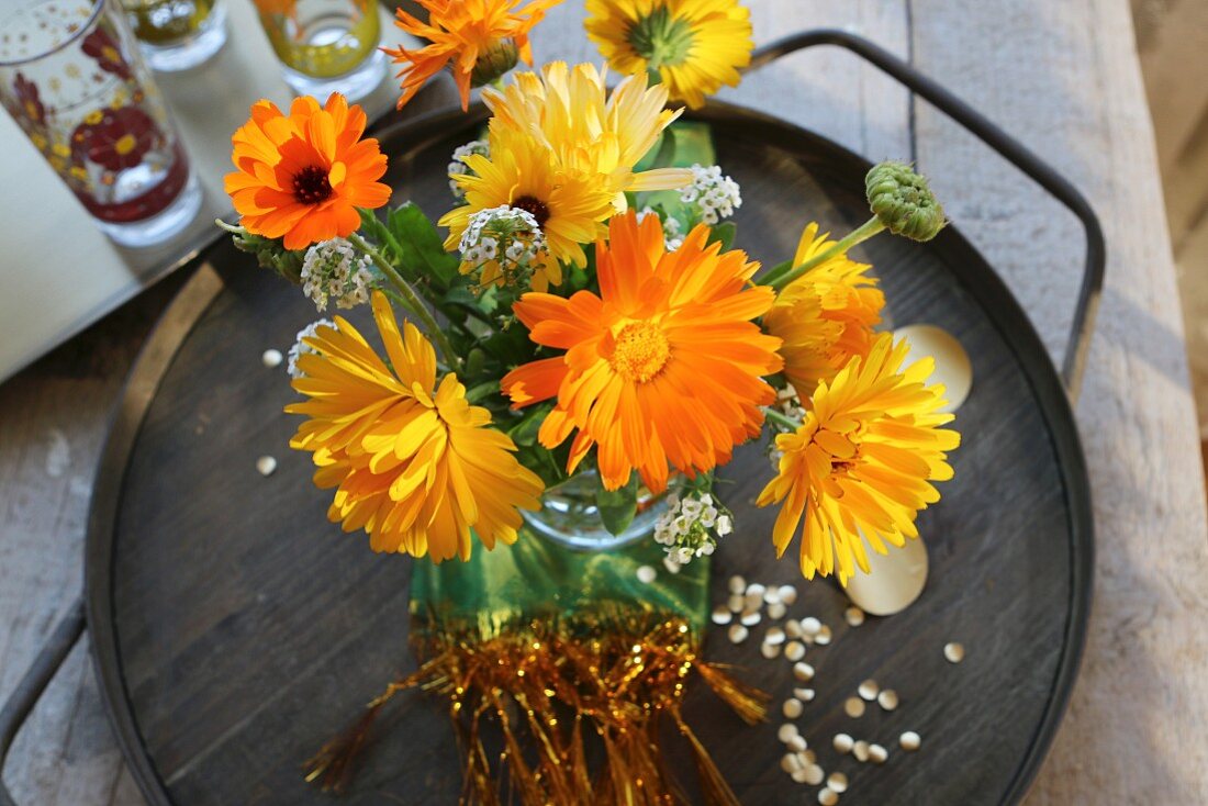 A bouquet of yellow asters on a tray