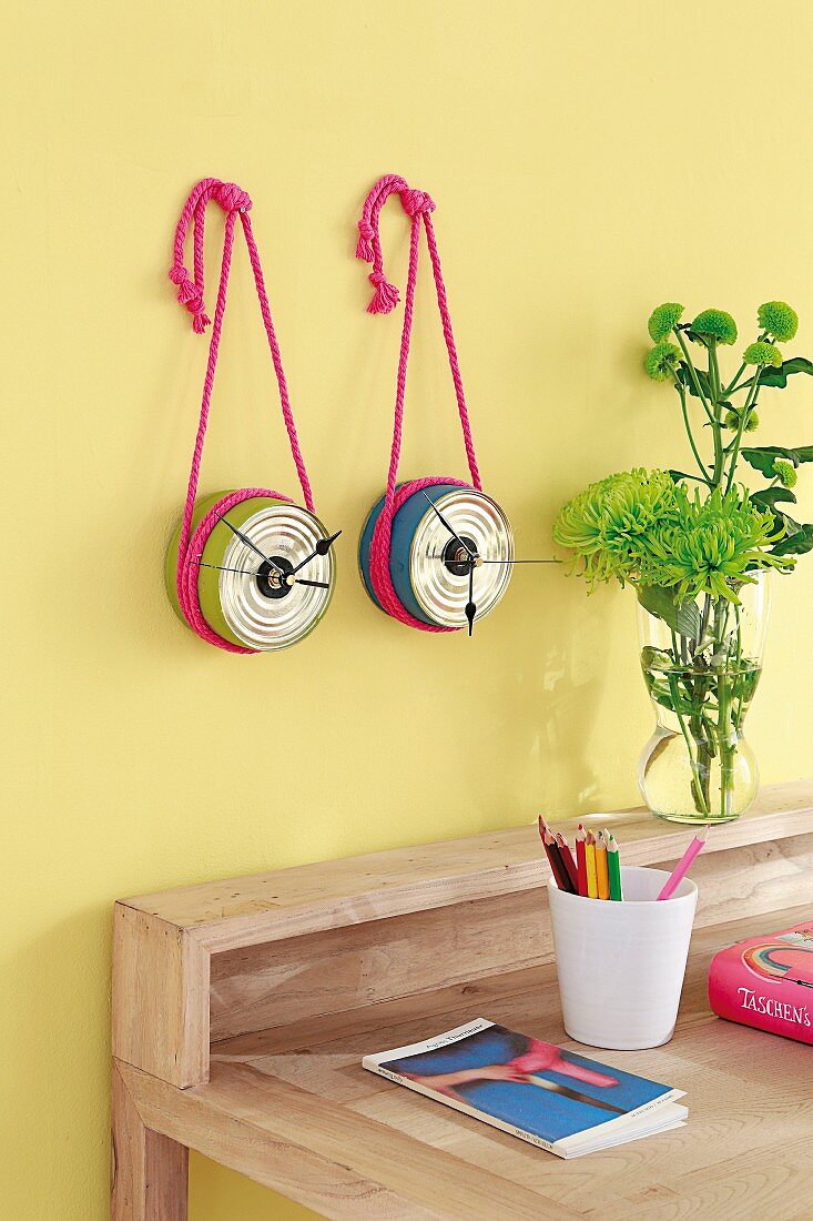 Wall-mounted clocks hand-crafted from tin cans