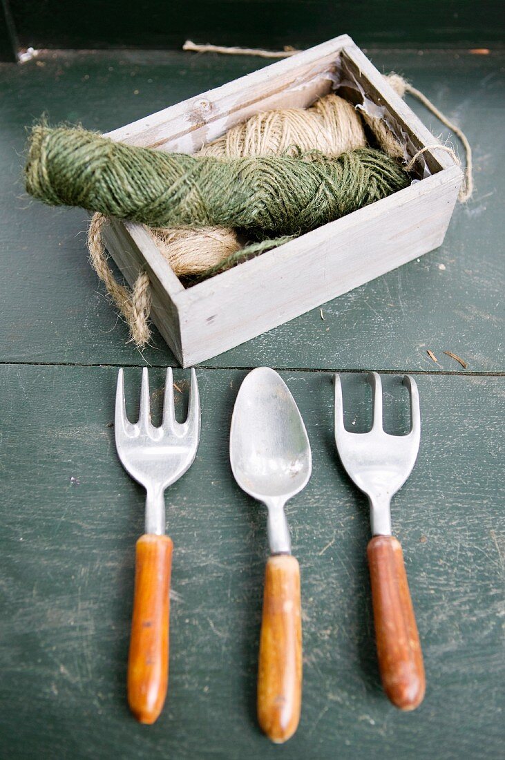 Gardening tools and reels of twine in wooden crae