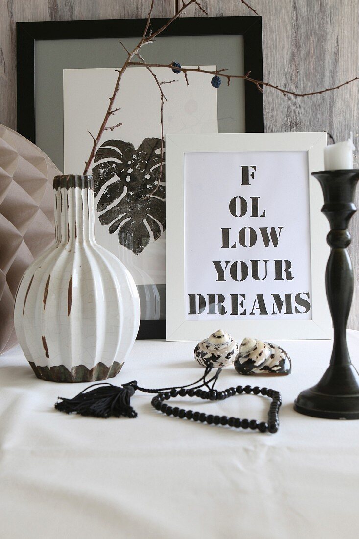 Framed pictures with printed lettering and black and white leaf print