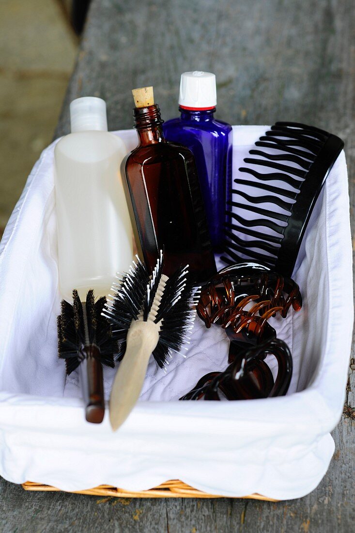 Hair brushes, combs and toiletries in white-lined basket