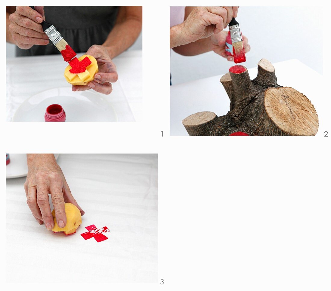 Painting both a potato stamp with cross motif and the cut surfaces of a wooden stump red