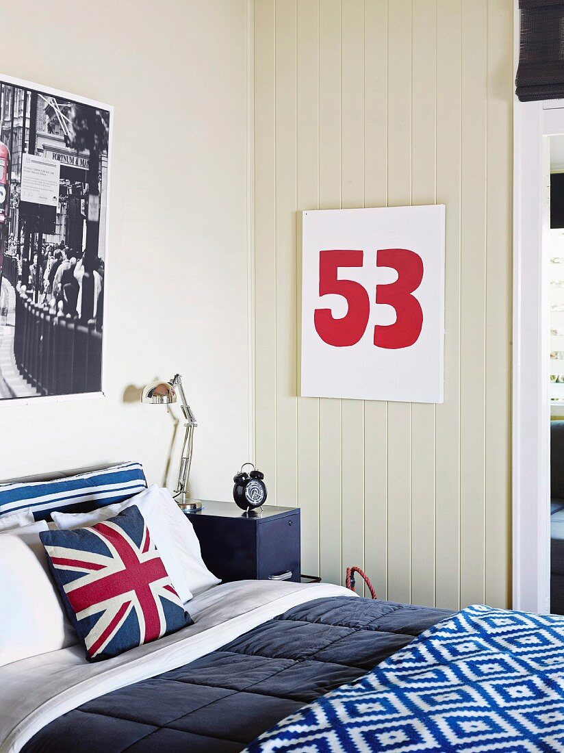 Bedroom with blue-white-red color accents, cushion cover with 'Union Jack' on bed