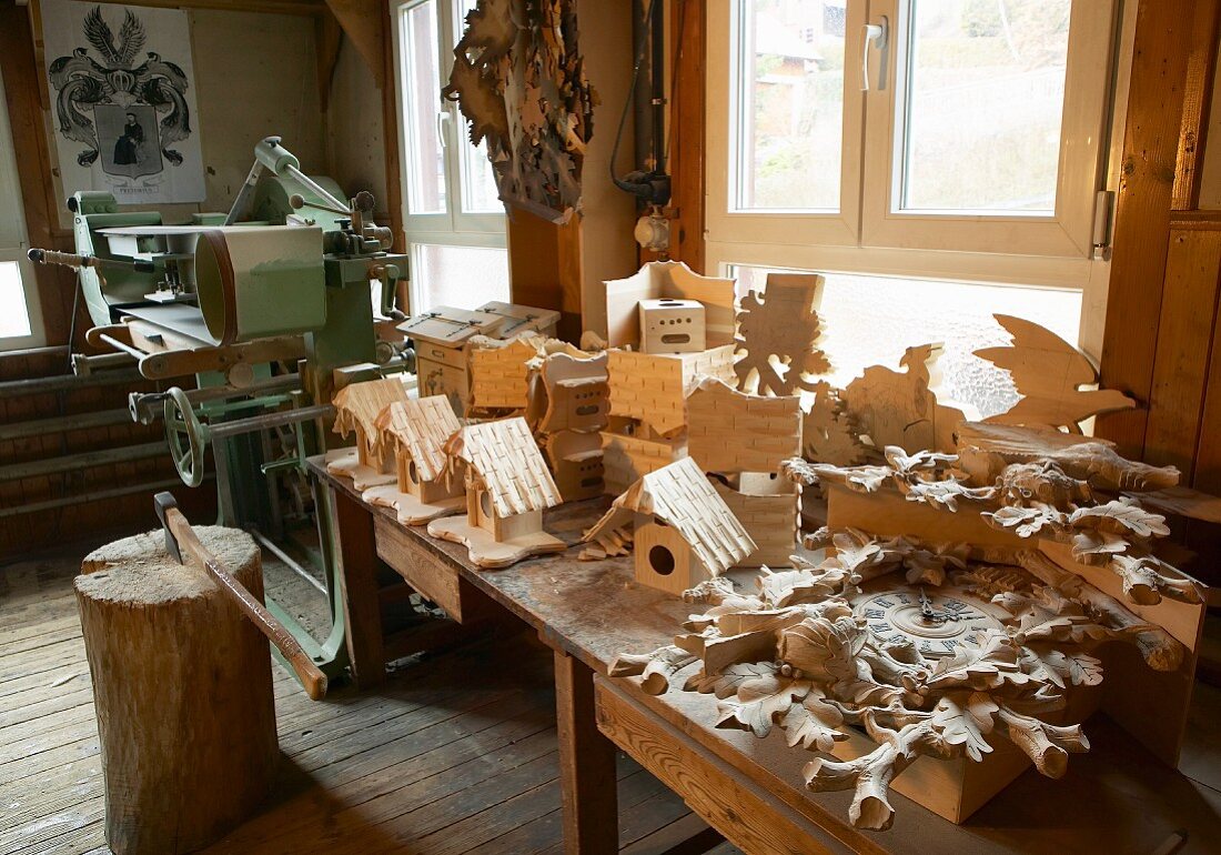 Elaborate cuckoo clock, bird nesting boxes and other carvings in traditional workshop