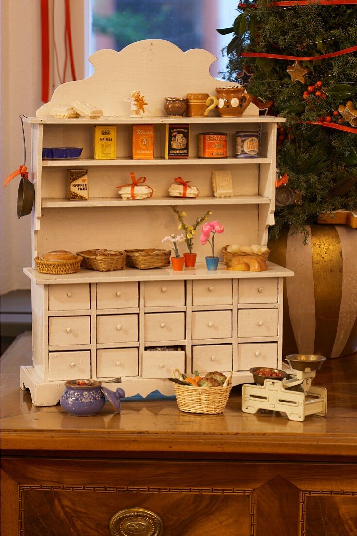 Old-fashioned Christmas toys: antique play shop with miniature groceries